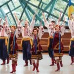 Grupa tancerzy wykonujących ukraiński taniec ludowy w strojach tradycyjnych
